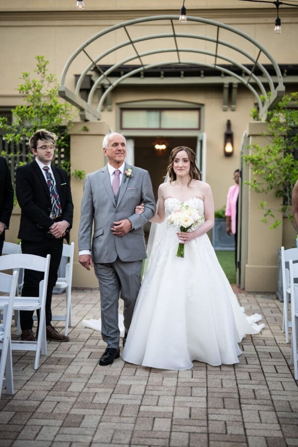 Bride and father walk up the aisle