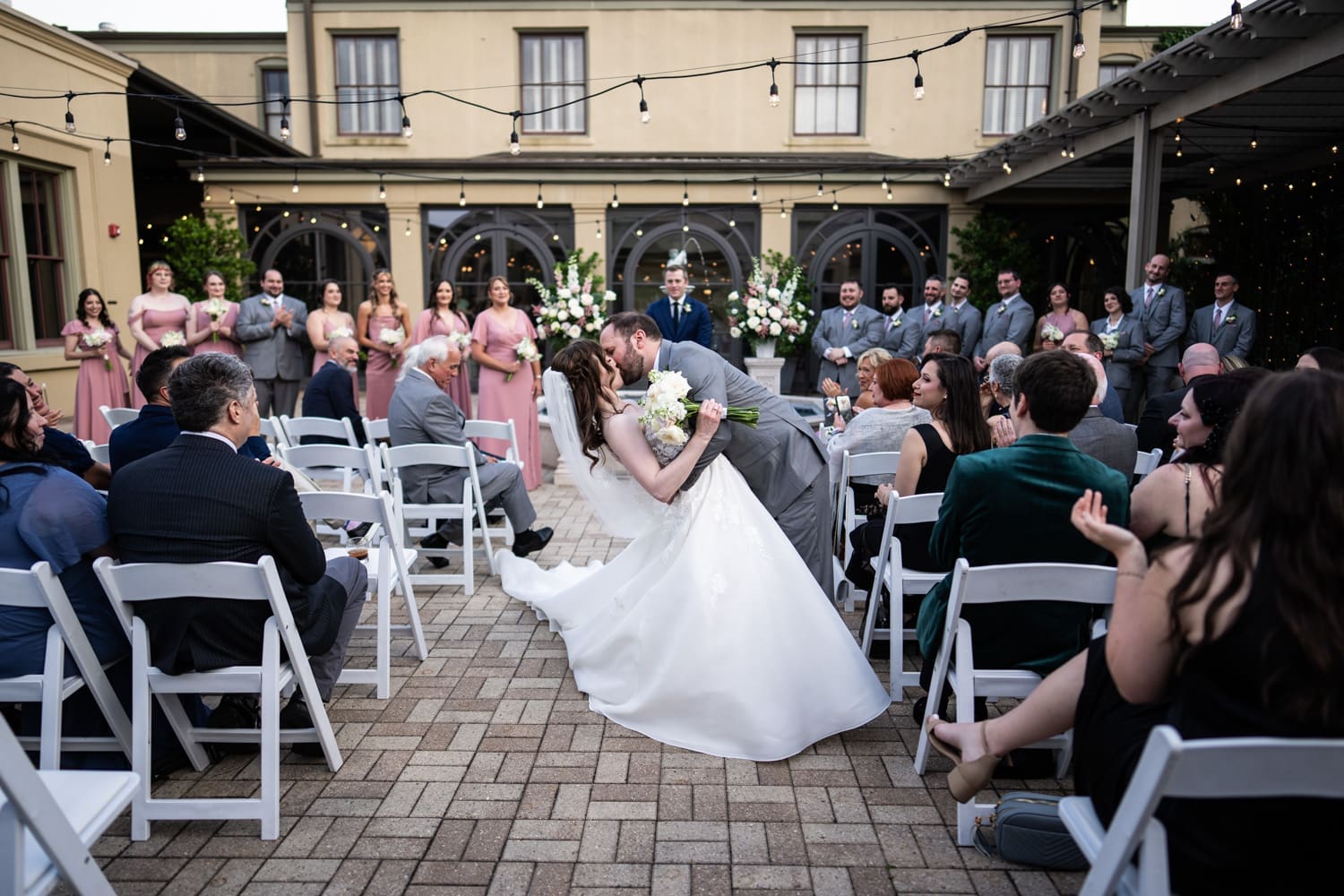 Groom dips and kisses bride at conclusion of wedding at Southern Hotel