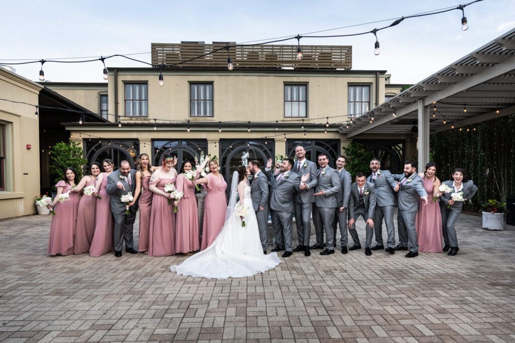 Wedding party cheers on the bride and groom as they kiss at the Southern Hotel