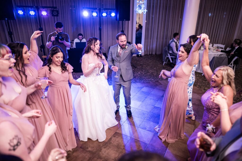 Bride and groom dancing with friends
