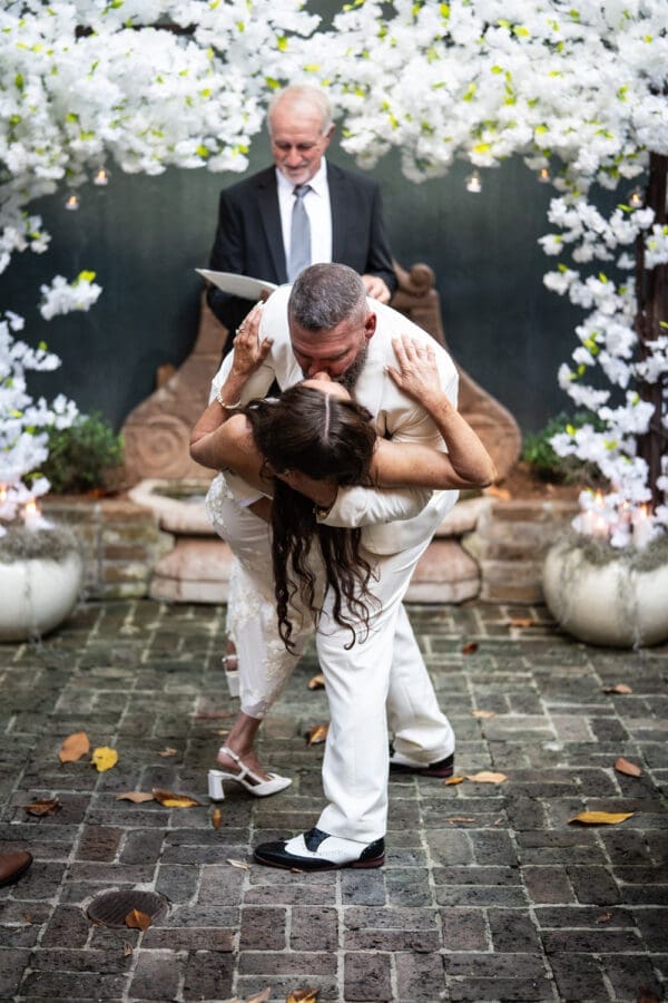 Groom dips and kisses bride