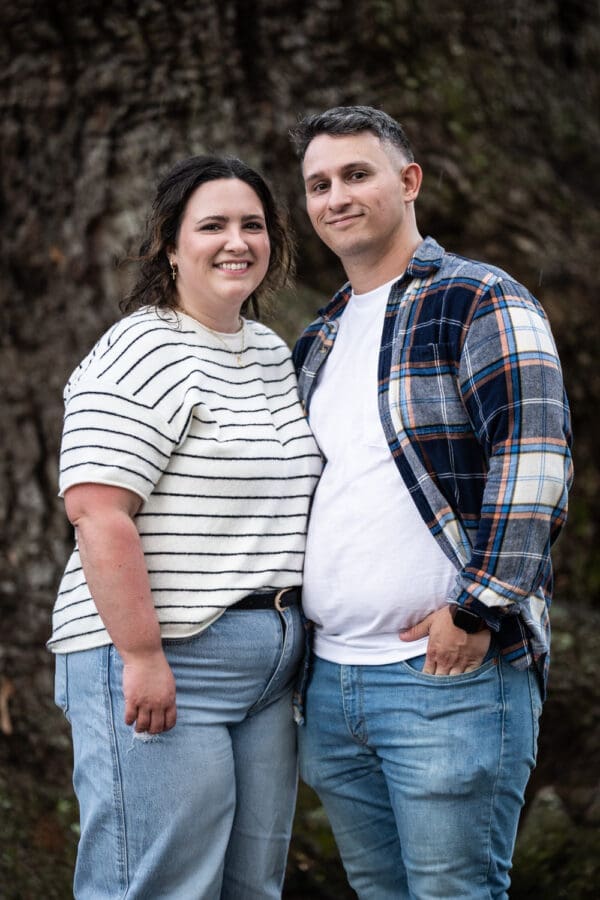 Couple standing in front of tree