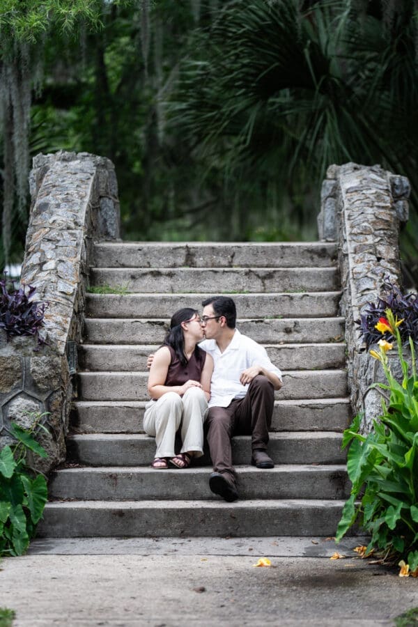 Couple kissing as they sit on Langles Bridge in City Park