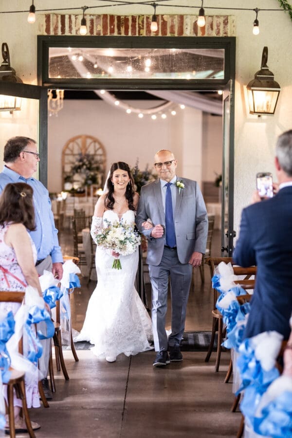Bride and father walk up the aisle at Dogwood Venue in Mississippi