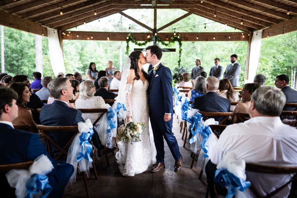 Bride and groom kiss at end of wedding ceremony at Dogwood Venue