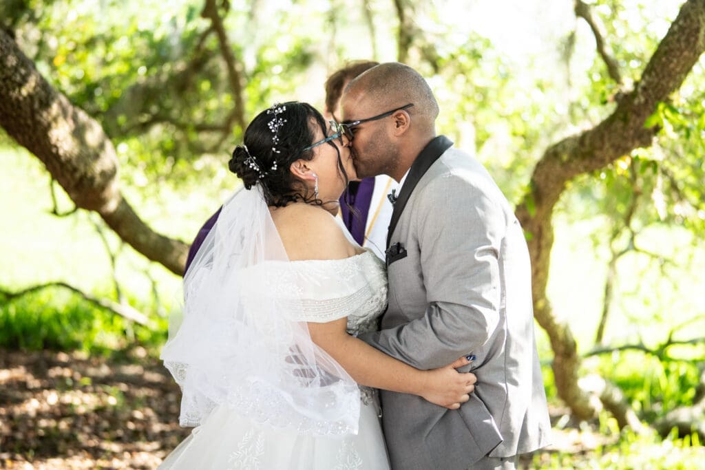 Couple kisses at conclusion of wedding ceremony