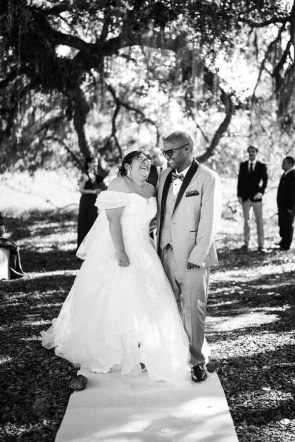 Couple laughs as they walk down the aisle