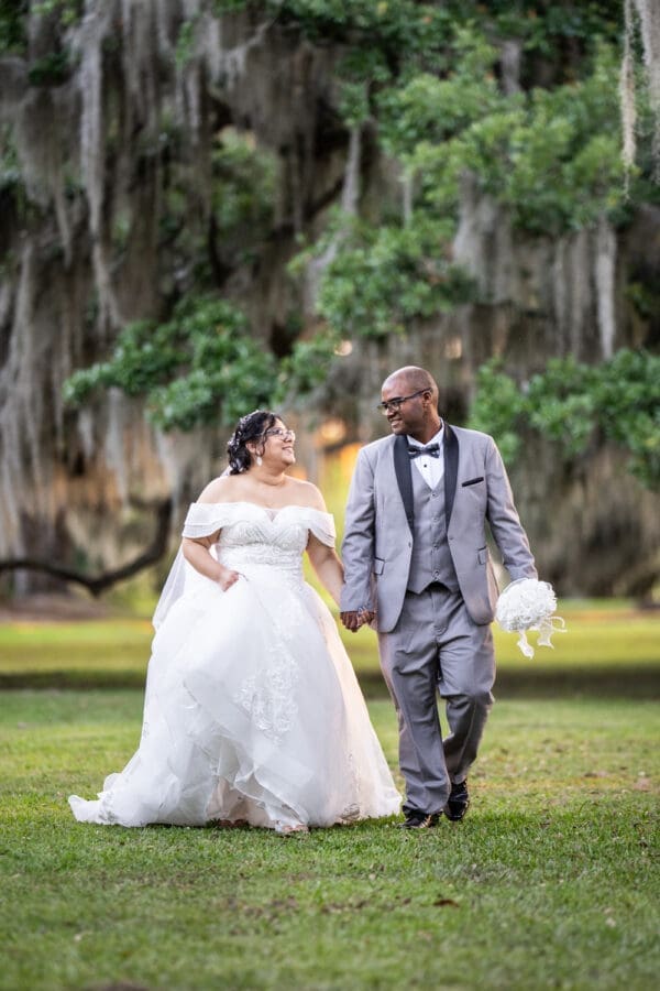 Bride and groom walking through Fontainebleau State Park