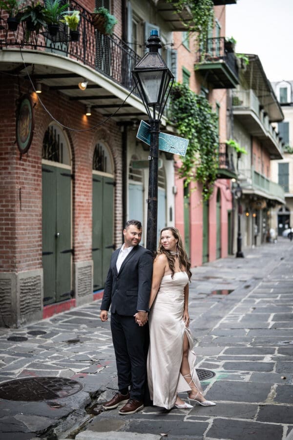 Couple leaning against lamp post in the French Quarter