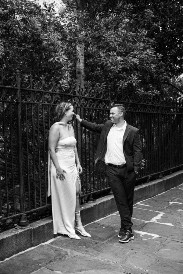 Couple by wrought iron fence in the French Quarter