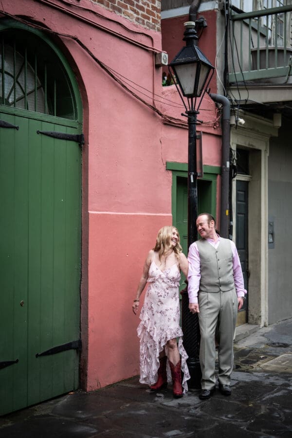 Couple standing by lamp post in Pirate's Alley
