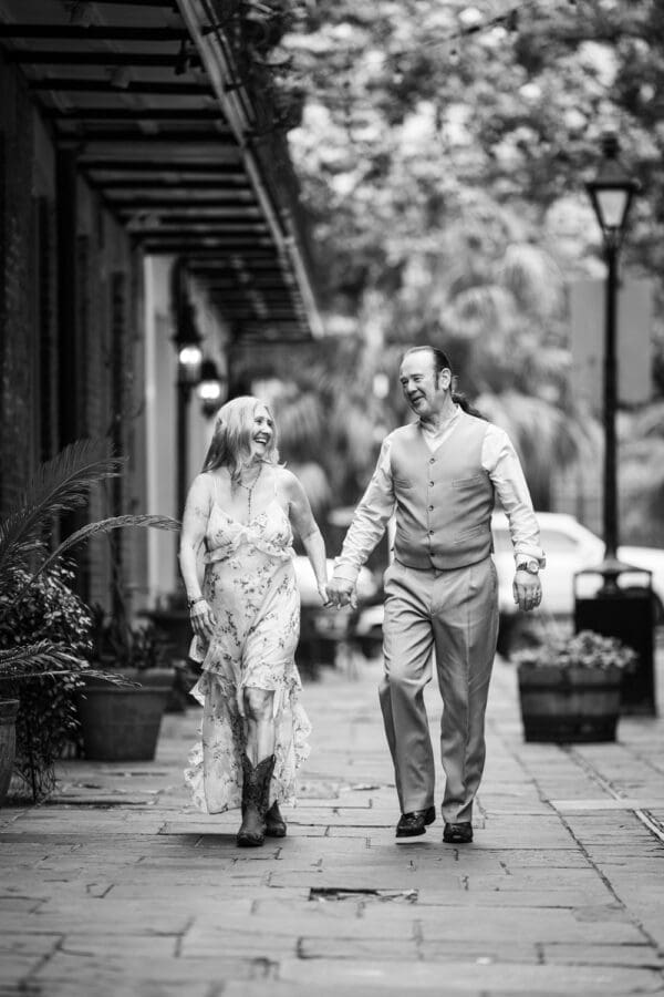 Couple walking through French Quarter as they hold hands