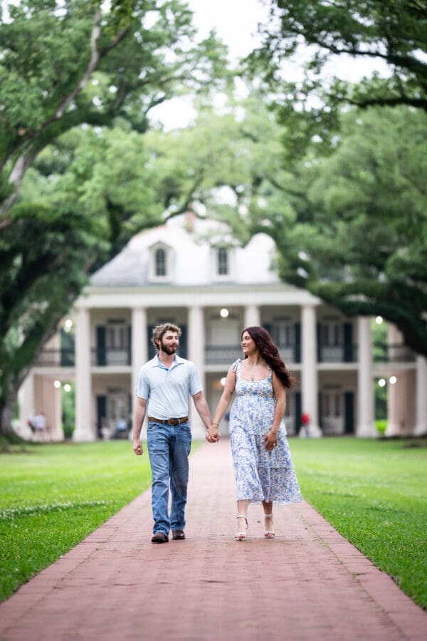 Couple walking along brick pathway at Oak Alley