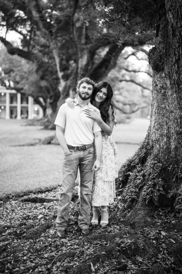 Couple standing next to large tree at Oak Alley