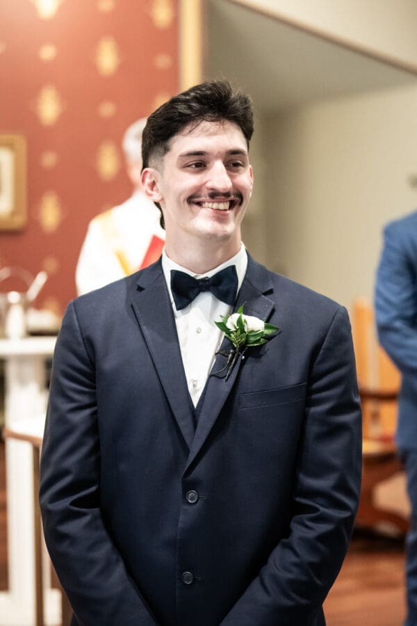 Groom watches bride walk up the aisle
