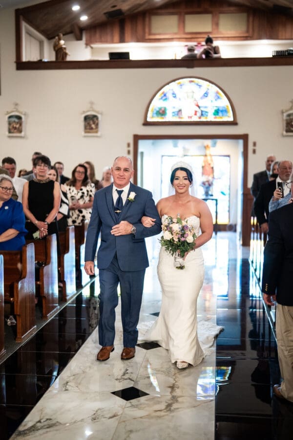 Bride and father walk up the aisle