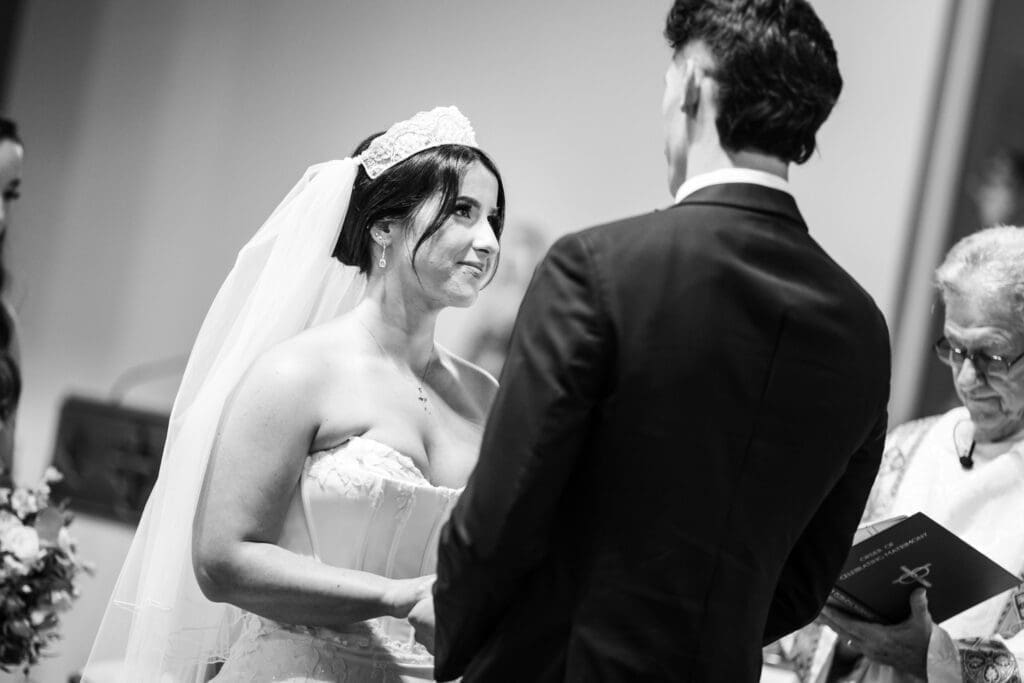 Bride smiles at groom during vows