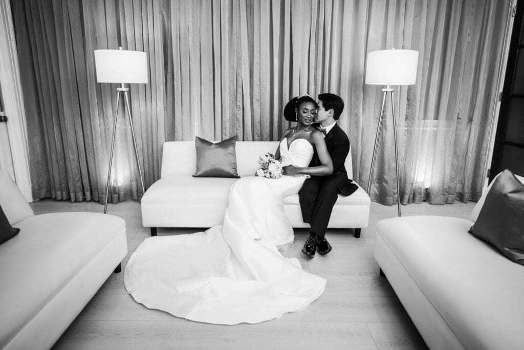Bride and groom sitting on sofa