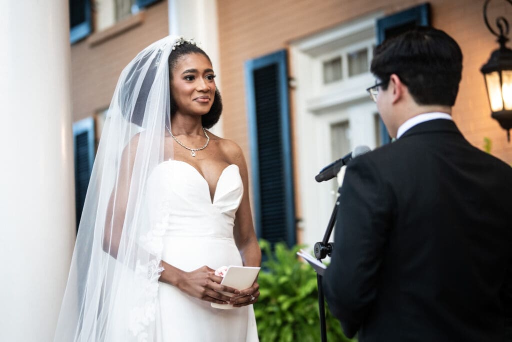 Bride listens to groom reading vows