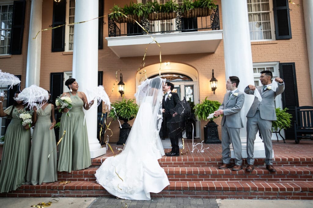 Bride and groom kiss as streamers rain down