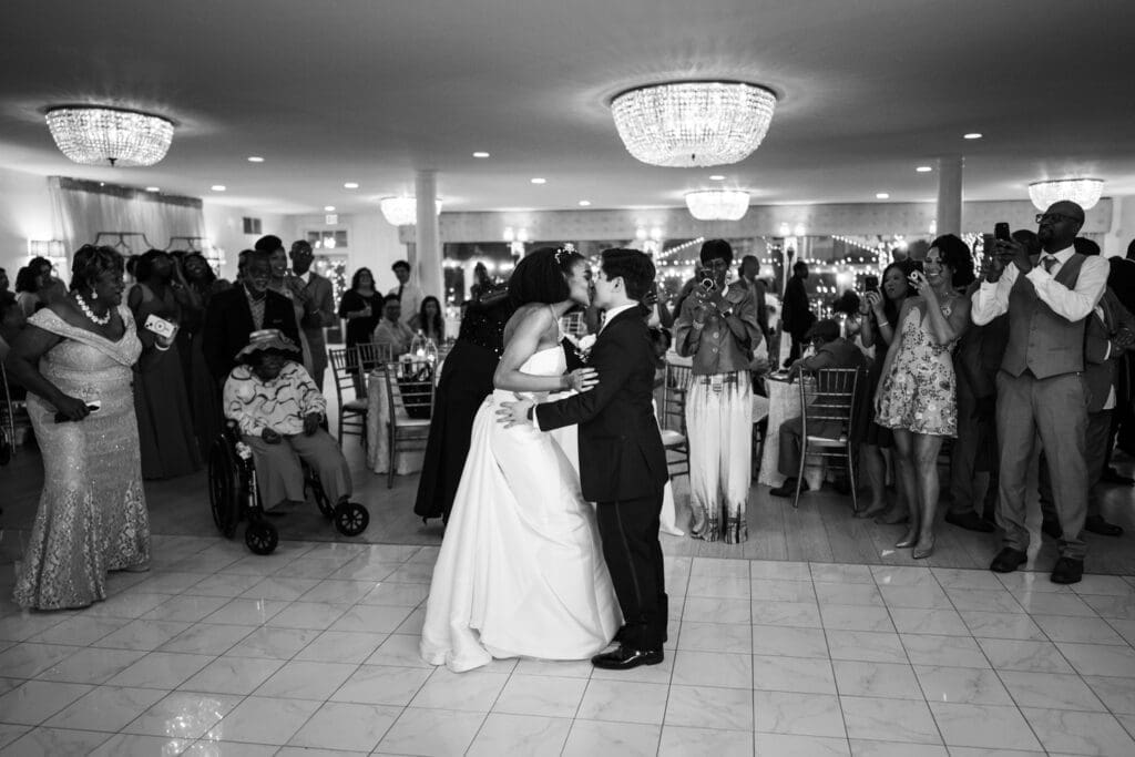 Bride and groom kiss on the dance floor