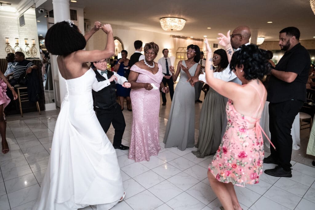 Bride and groom with their family on the dance floor