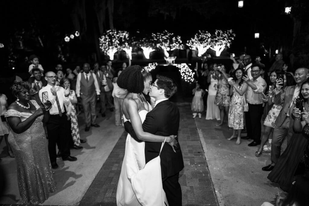 Bride and groom kiss during send-off from Southern Oaks