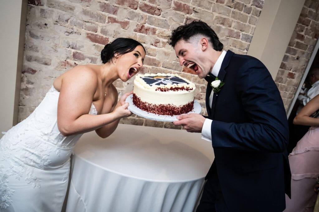 Bride and groom pretend to eat cake