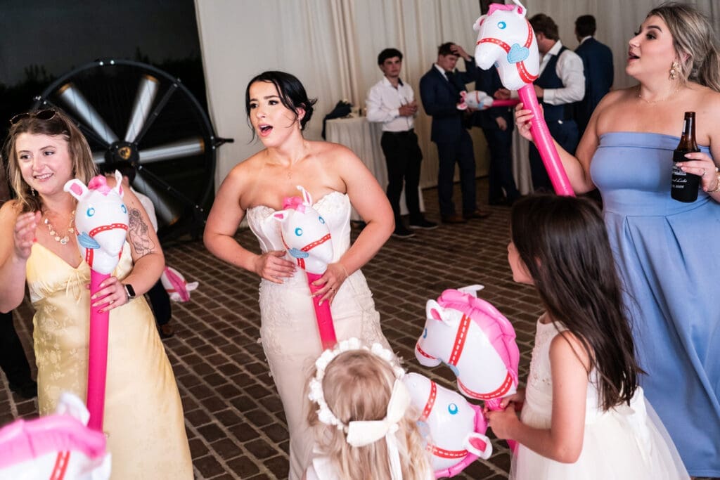 Bride and friends with inflatable horses