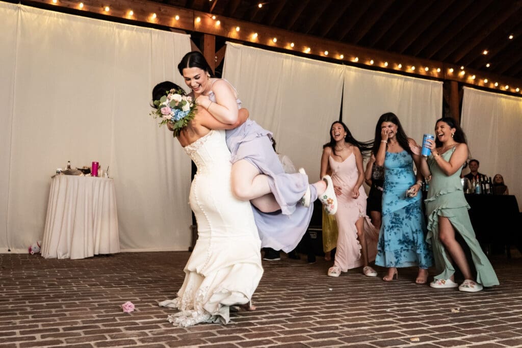 Bridesmaid celebrates catching the bouquet