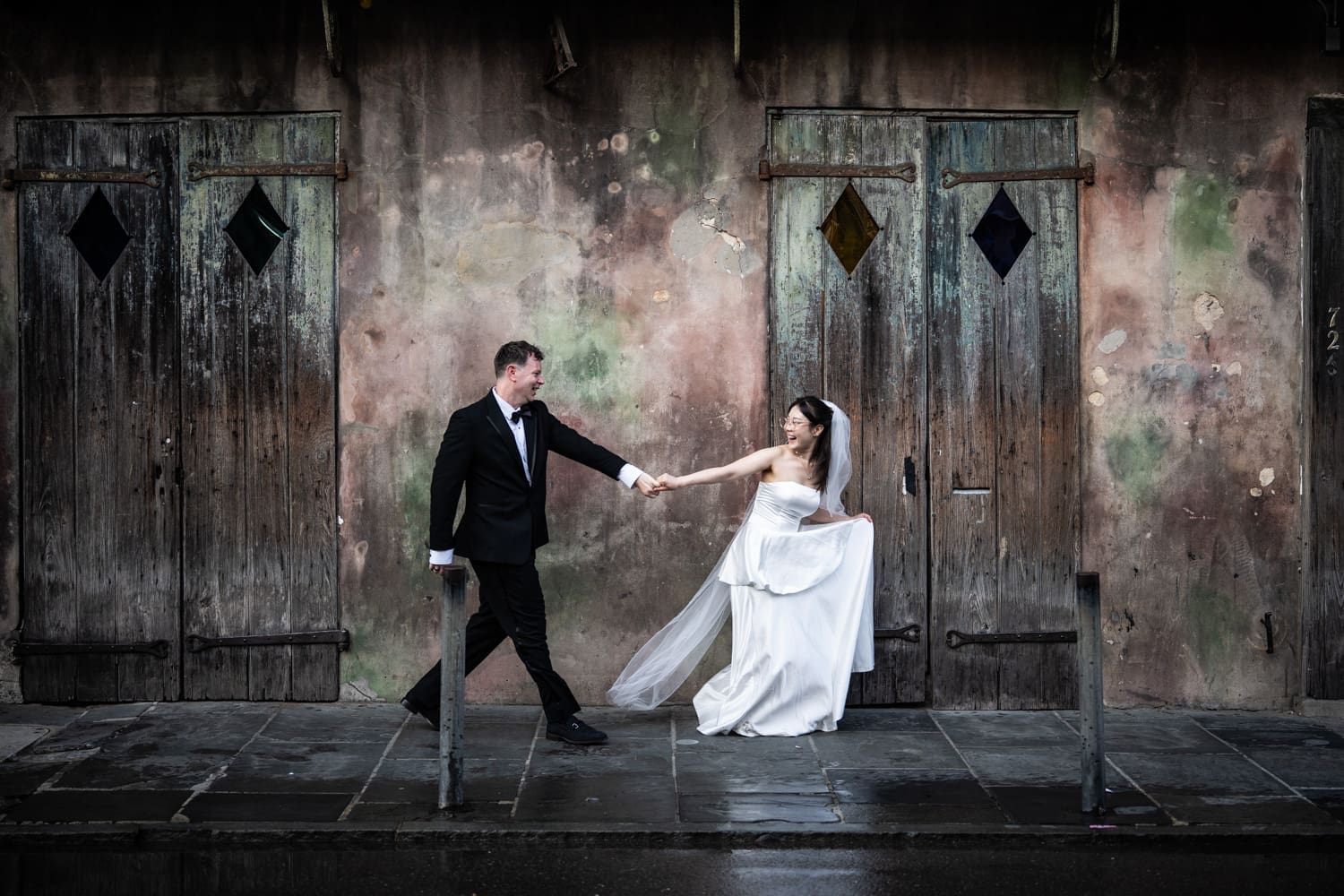 Bride and groom running in front of Preservation Jazz Hall in New Orleans