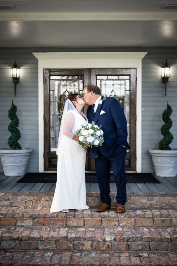 Bride and groom kissing on brick steps