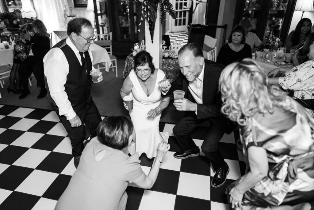 Bride and groom with guests on dance floor
