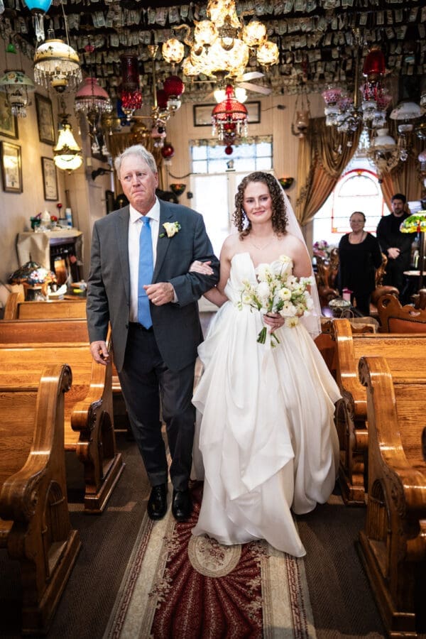 Bride and father walk up the aisle