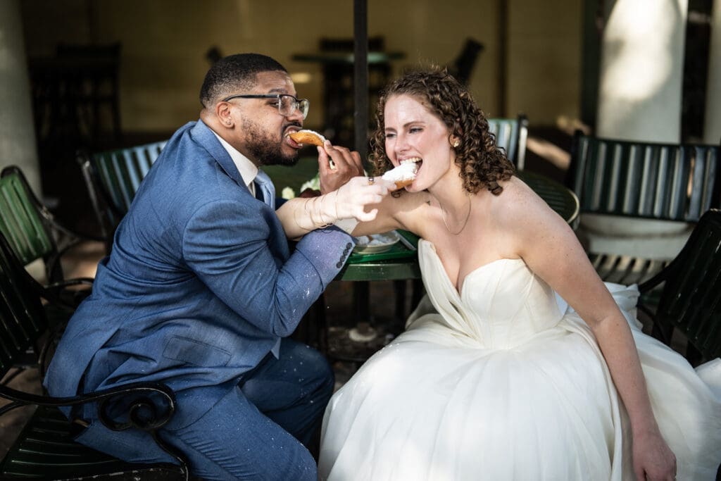 Bride and groom eat beignets