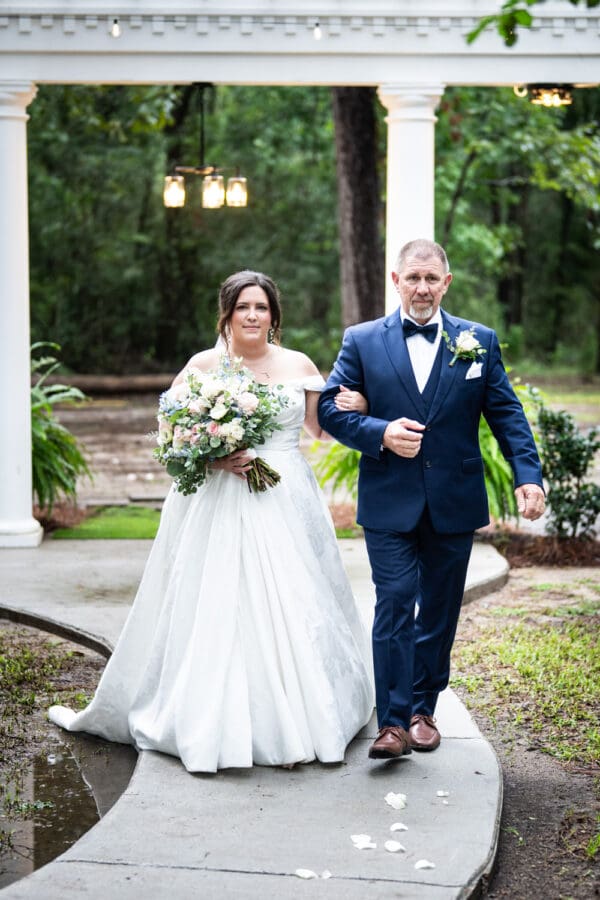 Bride and father walk up the aisle