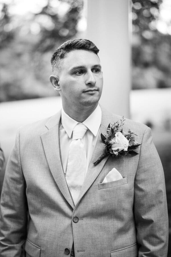 Groom watches bride walk up the aisle