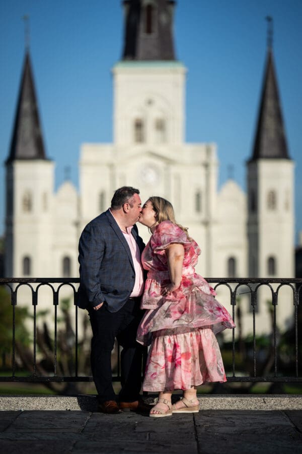 Couple kissing with St. Louis Cathedral in the background