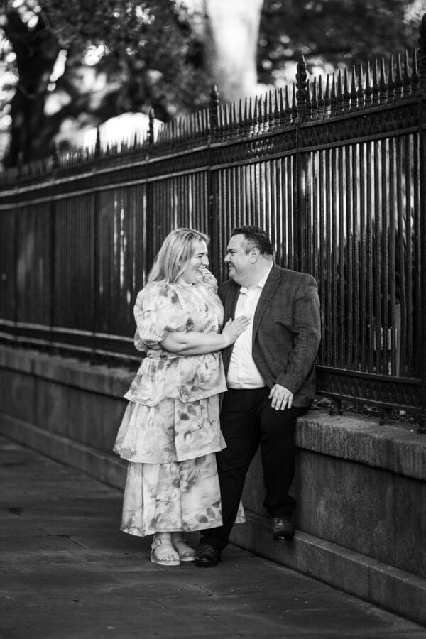 Couple by wrought iron fence in the French Quarter