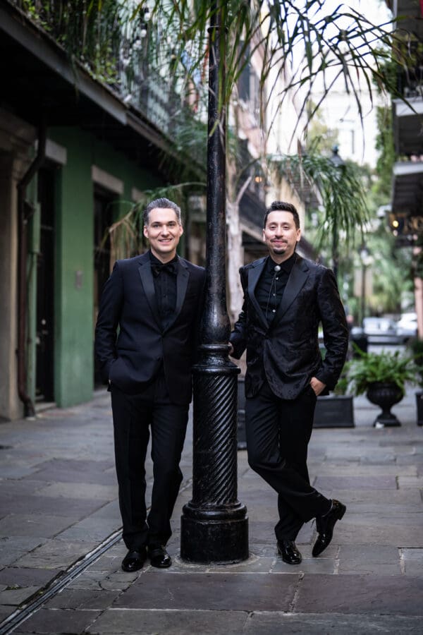 Two grooms standing by French Quarter lamp post