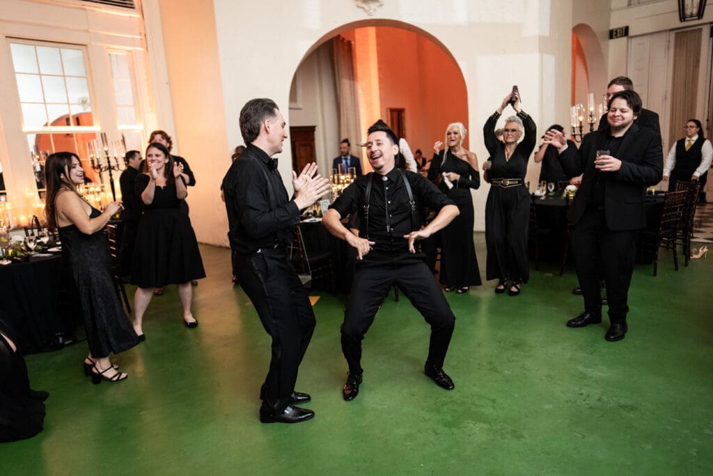 Grooms dancing with friends