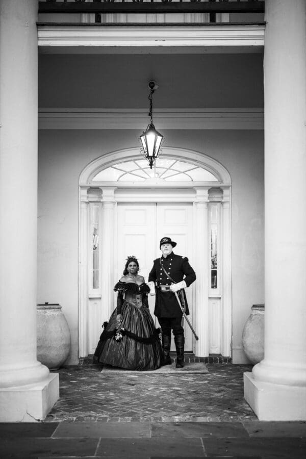 Man and woman in Civil War era attire in front of door