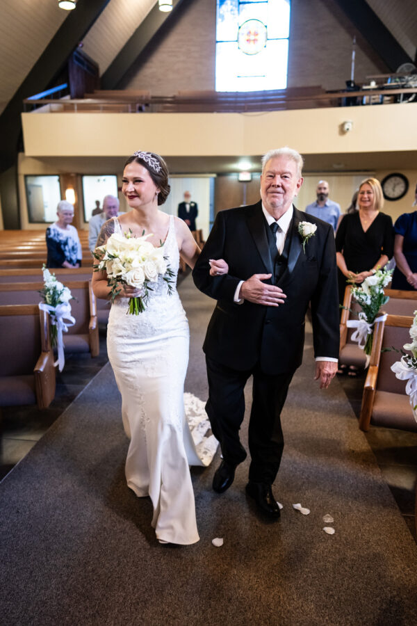 Bride and father walk up the aisle