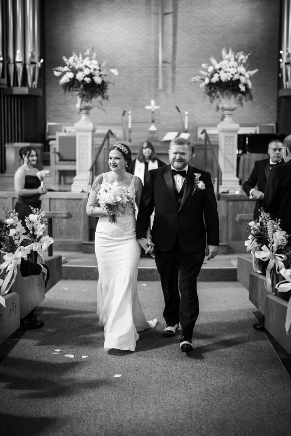Bride and groom walk down the aisle at conclusion of wedding ceremony