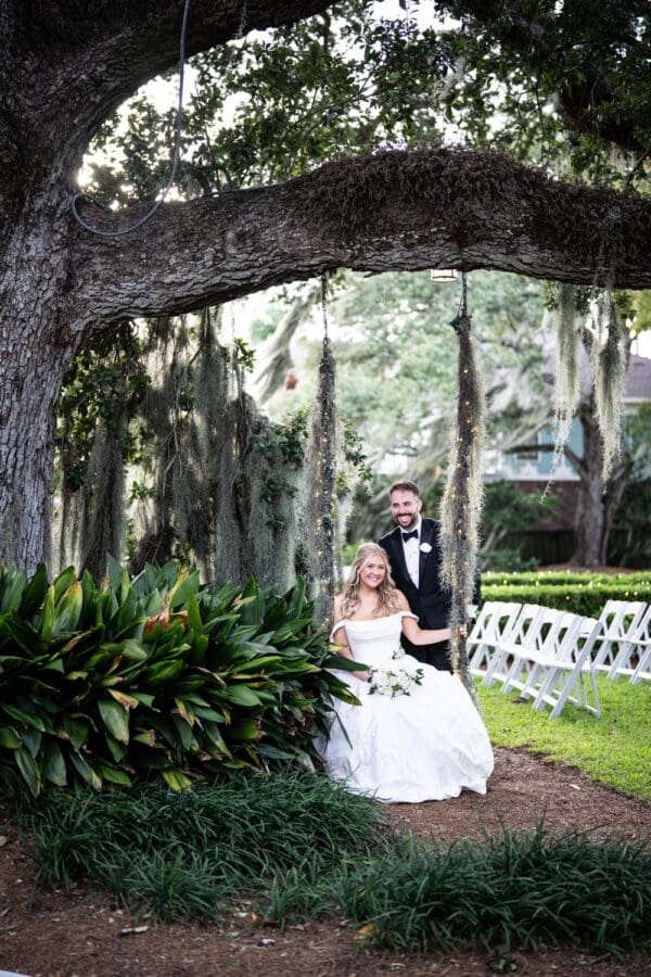 Bride and groom on Southern Oaks tree swing