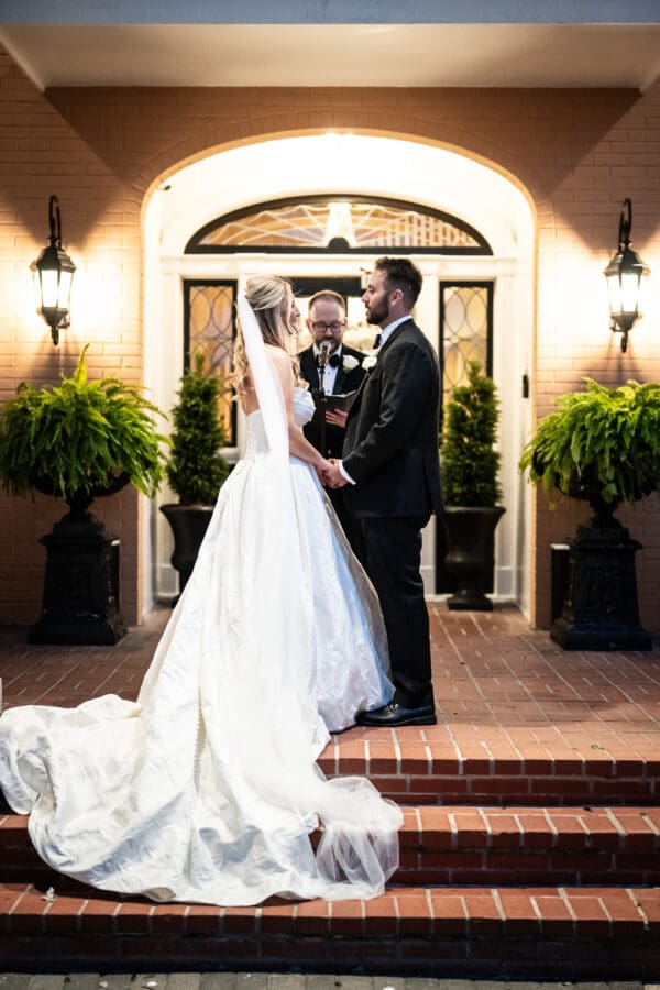 Bride and groom hold hands during wedding ceremony