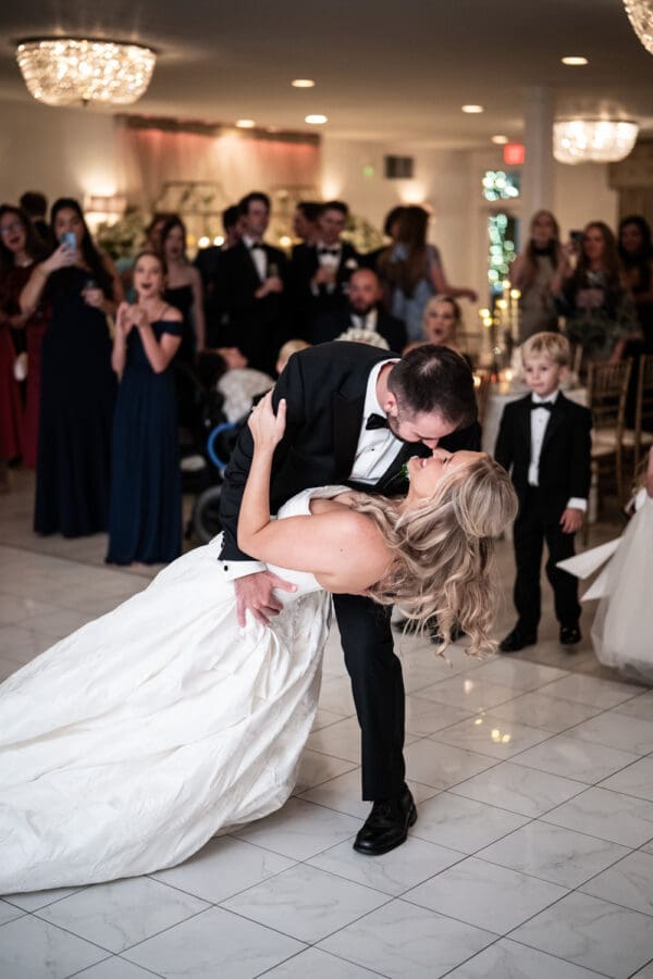 Groom dips bride during first dance