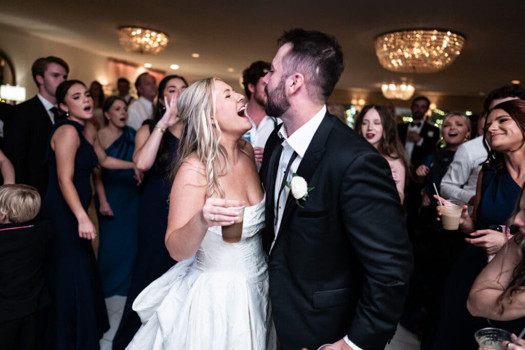 Bride and groom dance with guests